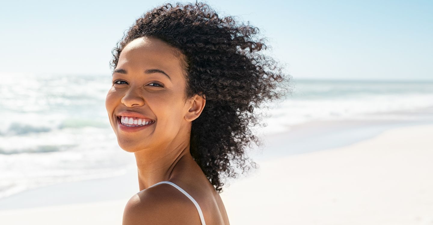 a smiling woman on the beach